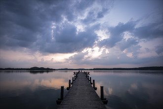 Footbridge into the Woerthsee shortly in front of sunrise