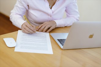 Woman proofreading at her desk