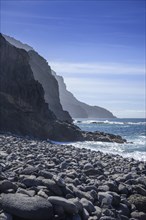 The beach framed by rocks at Playa del Trigo