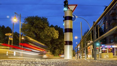 Moving trams at an intersection with a speed camera column