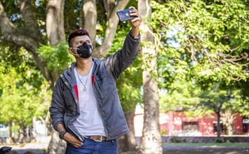 Young man with mask taking a selfie