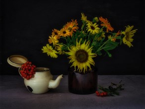 Still Life with Autumn Flowers in Glass Next to Rowan Berries in Old Teapot