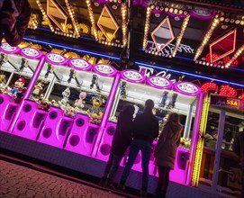 Colourfully illuminated slot machines at a fair