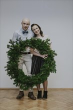Man and woman with fir wreath