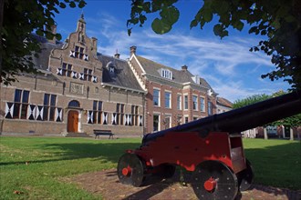 Cannon in front of typical Dutch houses