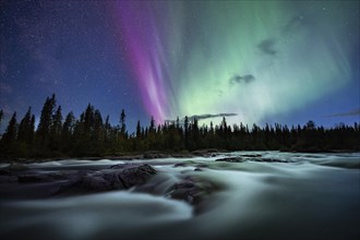 Northern Lights or Aurora Borealis over River Gamajahka or Kamajakka