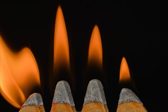 Four flames on match heads