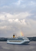 Cruise ship Costa Magica with rainbow in the harbour of Bergen