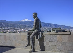 Statue of Humboldt behind the snow-capped Teide