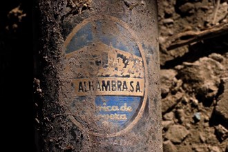 Dusty patina covered beer bottle with logo on the bottom