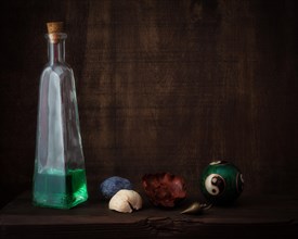Still Life with Qi Gong Ball Next to Bottle with Green Liquid