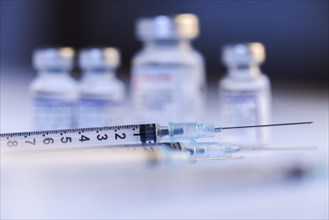 Syringes and various vials with vaccine against Corona