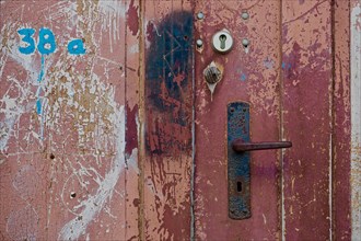 Rusty door handle on painted door