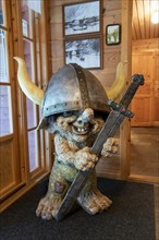 Figure of a troll with sword and helmet in Loen