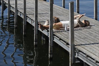 Woman lying on a jetty