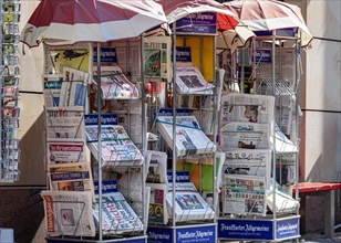 Daily newspapers and international press on display at the newsstand