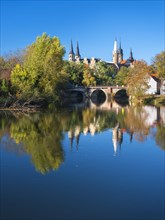 Merseburg Cathedral and Merseburg Castle reflected in the river Saale in autumn