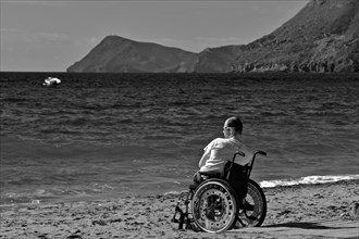 Man in wheelchair by the sea