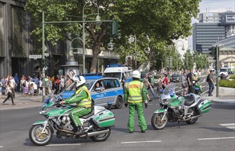 Traffic police officers on a motorbike regulate traffic during a demonstration