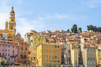 Colourful house facades of Menton with the Basilica Saint Michael Archangel