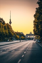Empty street of June 17 in the morning with Brandenburg Gate and Berlin TV Tower