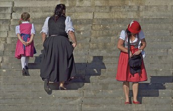 Women in dirndl on stairs
