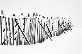 Snow fence in wintry landscape