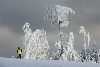 Deep snowy winter landscape and photographer on the Kahler Asten in Sauerland