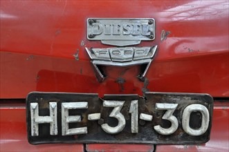 Rear of a red Ford diesel car with old number plate