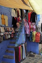 Staircase to shop hung with clothes