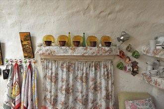 Curtain with decoration of objects from kitchen of cave house