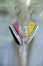 Sneakers as keychain on leash at market