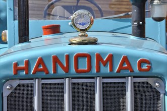 Hanomag logo with radiator figure on turquoise metal from tractor