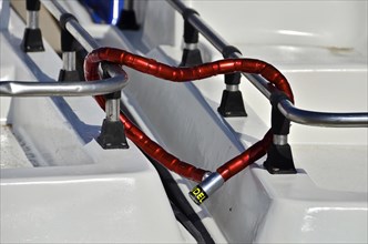 Red combination lock connects 2 heart-shaped boats