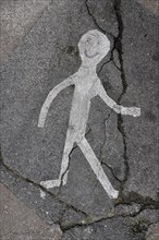 Walking stick figure on road
