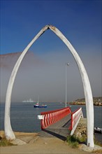 Whalebone gate in front of a jetty