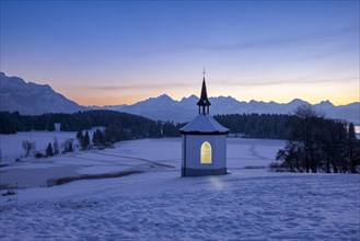 Hegratsried Chapel at Lake Hegratsried with a view of the Tannheim Alps