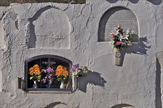 Graves with coffin niches in wall in a cemetery