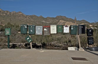 Several mailboxes next to each other on a street