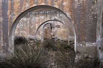 Abandoned house with round arches