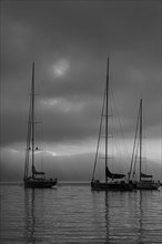 Sailing yachts anchored at sunrise in Portofino Bay