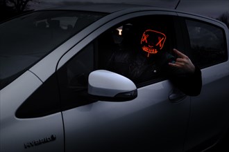 Man with Purge mask in car