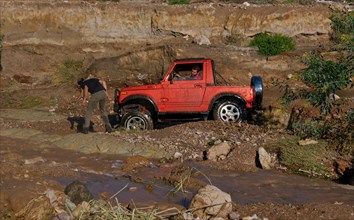 Stuck off-road vehicle in mud hole