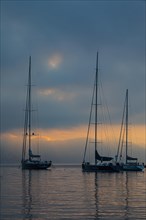 Sailing yachts anchored at sunrise in Portofino Bay
