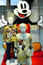 Shop window with children's fashion dolls in Mickey Mouse clothes