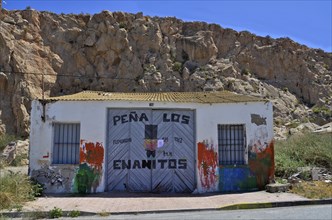 Boat shed with graffiti painted door in Aguilas