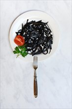 Black pasta with squid ink on plate