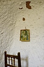 Picture on white wall with chair back