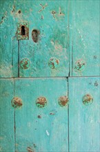 Wooden door with metal nails