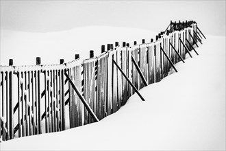 Snow fence in wintry landscape